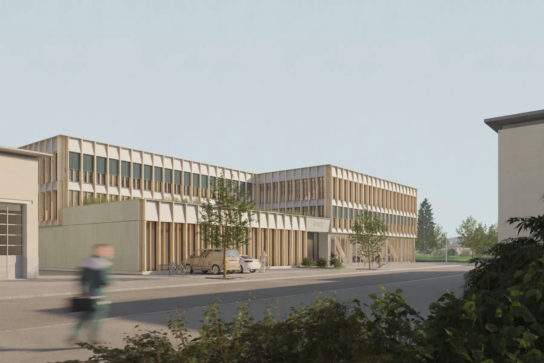 Geb&auml;ude mit Holzfassade und einigen B&auml;umen im Vordergrund